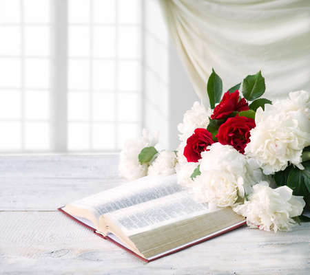 Old ancient jewish wed love prayer desk text space. Holy age pray god Jesus Christ gospel diary art lush fresh red flora bloom bud plant petal indoor house room interior wall view still life symbolの写真素材