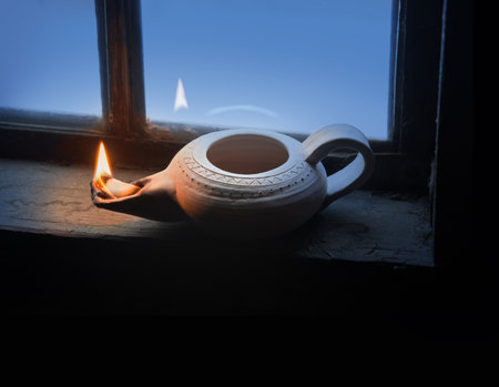 Closeup view rural middle arabian shiny jug jar wick blow glass even sky text space. Close up holy bible magic arab rustic past age biblic poor hot hut black room god faith pray spiritual symbol styleの写真素材