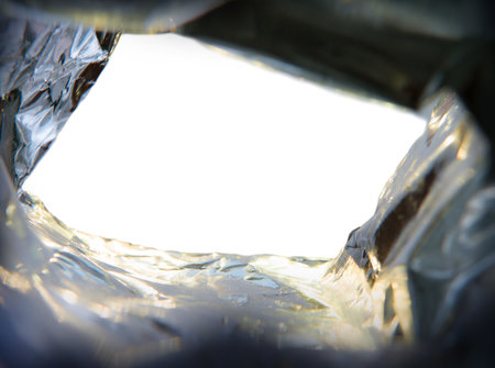 Close up bottom upward detail macro big large blank light gold plastic cold protect wrap tinfoil...
