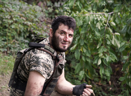Tired USA patriot nato navy unit guy sit rest hand camo protect look hope danger hurt summer forest...