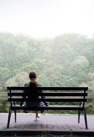 Young adult 1 lady feel worry anxiety anxiety cry pray mood seat dark gloomy hill white mist fog sunset sky view text space. Lost love upset sorrow morn forest travel fall life prayer wait see god faithの写真素材