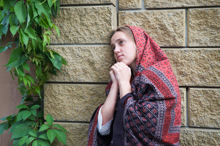 Mental upset grief cry need teen jew lady street home think ask beg hand Lord peace love help. Old retro biblic jewish shawl kid child suffer crisis stone wall israel church temple house bible conceptの写真素材