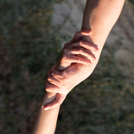 Close up old despair stress pray young male guy finger extreme sport achieve union worker god trust hope pit Closeup addict girl prayer ask raise rock cliff abyss free power social trap escape overcomの写真素材