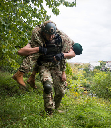 Brave old USA nato navy force unit guard male guy hand gun shot hurt protect hope pray pain ptsd danger life fight fire dark black fog mist smoke field sky. Human arm aid prayer girl hero stress shockの写真素材