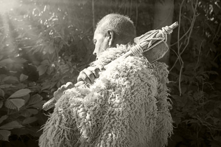 Closeup past retro primev archaic neolith era native culture strong savage craft mallet worker battle arm forest tree. Close up view dirty sharp steel iron stick rope beat nomad farm work warfare signの写真素材