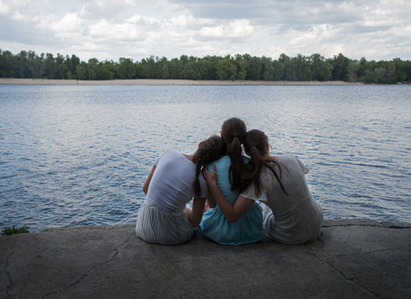 Sad rural adult family behind rear view hand arm funny love travel life light sky text space. Glad joy lady mom trust chat fun child kid look peace morn sea camp even sunset city dock water quay sceneの写真素材