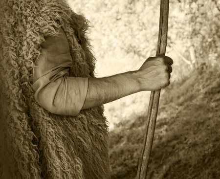 Close up retro rustic tool medieval rural herd devot adult age wise herder worker saint prayer John baptist Middl east holy jew Joseph fur robe cloth walk Lord pray hope bible story rod symbol conceptの写真素材