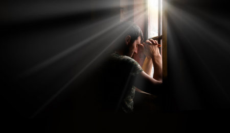 Tired pensive devote belief navy force young guy hero face cry hope hand pain love dark black old retro home room sun light text space. Worry human feel lost despair frown upset warfare believe conceptの写真素材