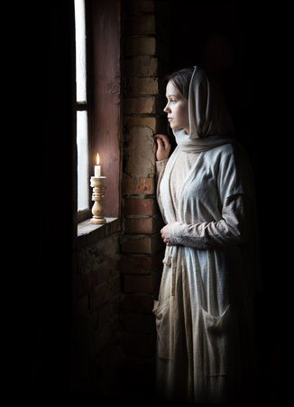 Lone retro rural veil cloth life sad poor lady face look cry plead bible. Holy cold kid child think ask beg old biblical god wait even flame light war home room text spaceの写真素材