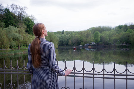 Young adult lady prayer feel worry mental grief anxiety cry mood stand spring urban city town shore...