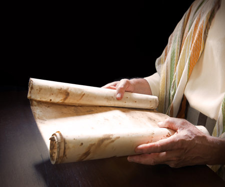 Closeup past history orthodox judaic god prophet faith church talmud law space concept Young age devot believ israeli male human preacher guy boy arm learn write worn note roll dark black tableの写真素材