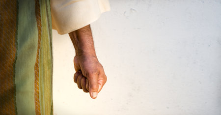 Past retro age bad rage mad cruel arab hate bible jew guy stand break force palm white wall text space Closeup brave power beat kill jewish woman hold fear against grasp vs stres grab grip win conceptの写真素材