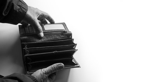 Closeup rich adult senior age guy arm dollar bill coin pouch bag case symbol. Close up top view earn new salary budget income wealth trouble stress female finger sale sign icon isolate whiteの写真素材