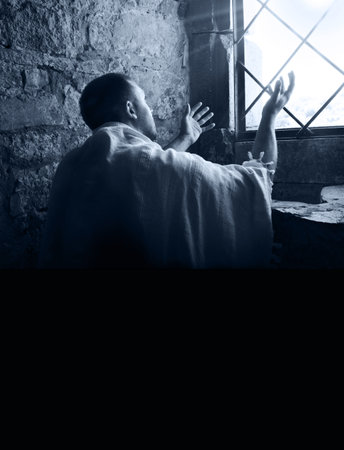 Retro east lone adult age guy face arm thank look sky holy spirit trust hope. Worry sad upset sin think praise concept wish ask beg plead lord love forgive dark church jail prison home room symbolの写真素材