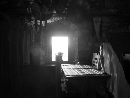 Young sad upset despair worry male human man prayer pray god faith light hope dream love. Teen lady veil dark black rustic fort hut stone wall live cafe bar fear bore grief war text spaceの写真素材