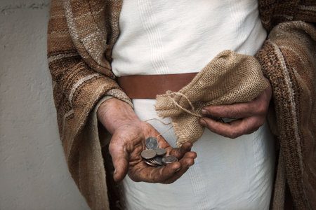 Retro east poor rustic male guy lucky lot price elder age finger give arm gift luck thirty alm profit fraud dollar deal bargain sack god story symbol conceptの写真素材