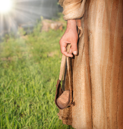 Young brave child character hebrew jew kid guy hero wear robe tunic dress cloth. Closeup judaic jewish israeli string sport athlete close up god belief target aim fieldの写真素材