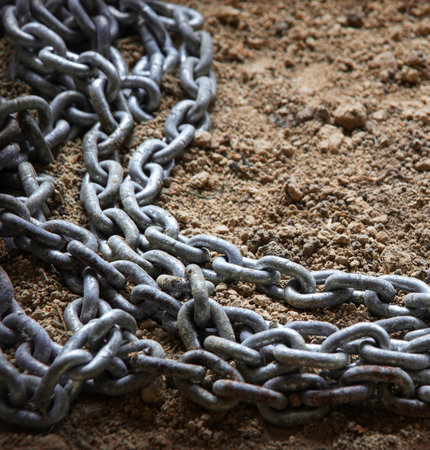 Rough grungy big solid hard grey chain bond tie safe part pile dirt sand soil earth coast text space backdrop. Close up top macro view rustic age rural restrict style unity signの写真素材