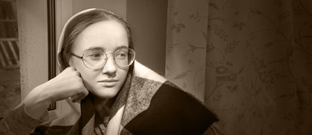 Young shawl lone sad mood feel teen lady worship pray see dark home room text space. Pious adult...