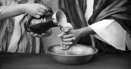 Closeup retro age east Israel jew temple rite sign pitcher pour wet arm. Female maid girl work serve master lord guy judge drink vase bottle body care easter story conceptの写真素材