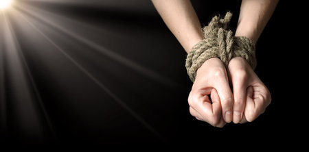 Closeup guy boy fist right finger ask god fear help hope dark text space. Adult old pain string cord lock bind wrist young sad stress lady restrain release addict convict religious christian controlの写真素材