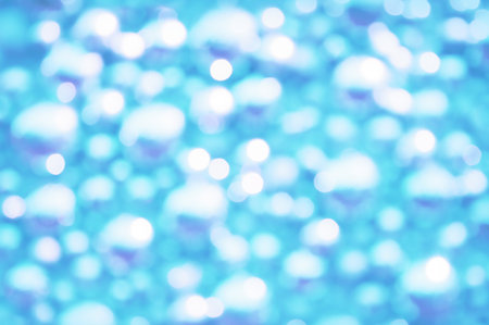 Awe beautiful christmaslight twinkly blue color dust glitz card copyspace area. Bright glittery de focus art soft sphere shape. Close-up view with space for text on teal glint merry xmas glowball sceneの写真素材