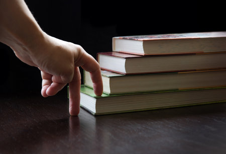 Closeup view vintag smart clever male guy teen boy pupil kid art tall high go top pile page group set retro data level class sign icon Close up grow devot lesson write paper dark black desk text spaceの写真素材