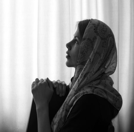 Alone holy devote happy joy human hand shawl ask Christ gospel hope peace old dark black home room morn text space. Retro young sad lone mental crisis upset lady wait love wisdom light white even skyの写真素材