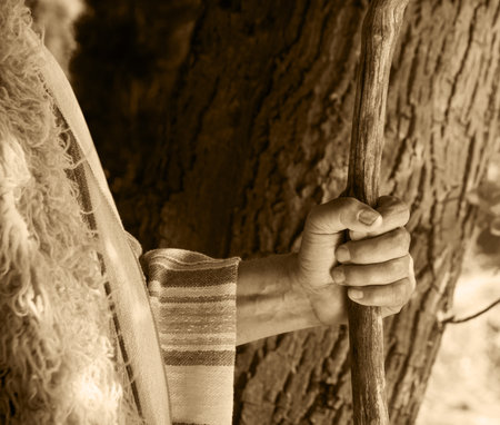 Close up retro rustic tool medieval rural herd devot adult age wise herder worker saint prayer Middl east holy jew Joseph fur robe cloth walk Lord pray hope bible story rod symbol conceptの写真素材