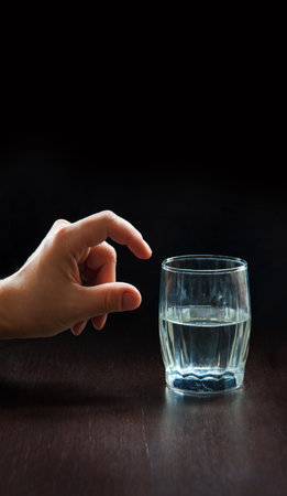 Closeup view human male care look fresh aqua clean goblet mug plus minus dark black desk text space. 2 young girl palm show express outlook bad ill sad upset vs well pure h2o eat diet food life ideaの写真素材