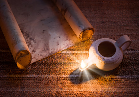 Worn rustic age holy jew faith torah author page dark black desk still life banner blank card. Closeup view diary literary art hand ink script text space oil light fire flame notice studyの写真素材