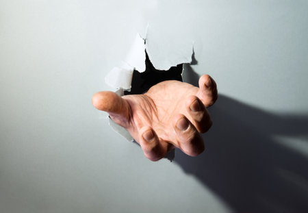 Old palm push on tear white empty page gap backdrop shot. Close up view retro dark dirty black girl grab pick take show sign icon idea concept blank back text spaceの写真素材