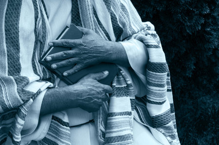 Closeup senior elder cathol church school new text paper page israel law concept Devot age jew guy pastor take word trust love hope jewish femal girl speak sacred saint biblic preach outdoor park treeの写真素材