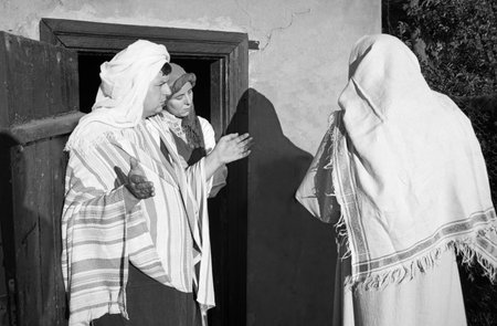 Jew age travel male beg plead don't want let room inn hotel home door East Asian arabic tunic robe cloth arab female girl Mary not deny reject refuse ban stay rural village street God xmas angel storyの写真素材