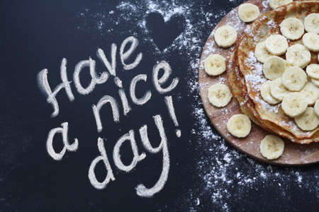 The inscription on the blackboard is chalky. Pancakes.