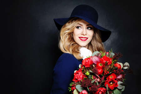Happy Lady Fashion Model with Flowers on Background with Copy Space for Text