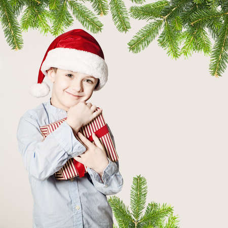 Small Boy Holding Christmas Giftの写真素材