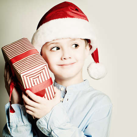 Christmas Curious Child with Giftの写真素材