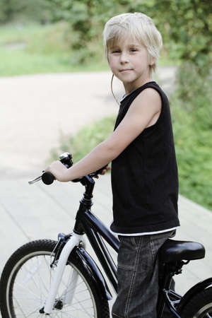 Cute boy and bicycle outdoorsの写真素材