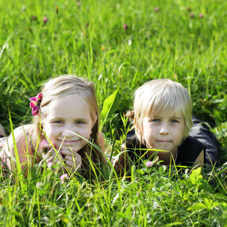 Kids on summer grass outdoorsの写真素材