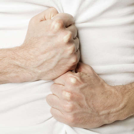 Man holding his stomach in pain or indigestionの写真素材