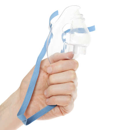 Oxygen mask in male hand on whiteの写真素材