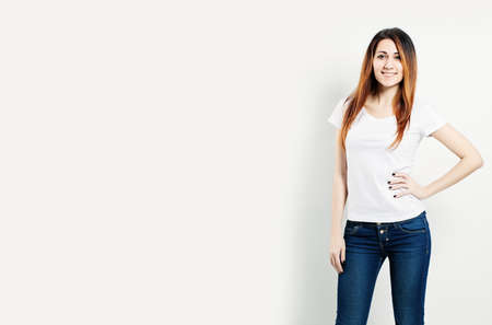 Smiling Woman Wearing White T-Shirt on Backgroundの写真素材
