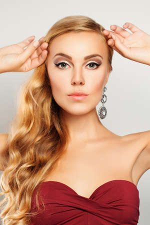 Beautiful Fashion Model. Woman with Makeup and Blond Wavy Hairstyleの写真素材