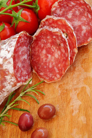 Gourmet food - salami, olives and rosemary herbs closeupの写真素材