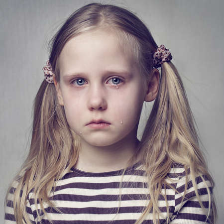 Little girl crying with tearsの写真素材
