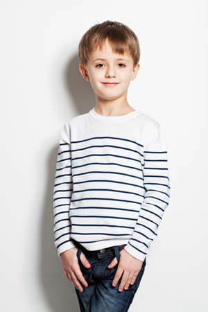 Cute little boy standing on backgroundの写真素材