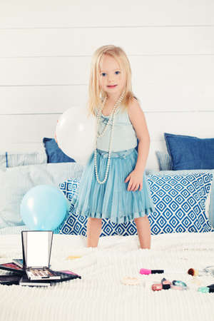 Cute Child Little Girl with Balloons at Homeの写真素材