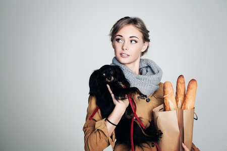 French Woman with Small Dog and Baguette on Background with Copy Cpaceの写真素材