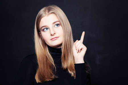 Girl Showing Up on Black Background with Copyspaceの写真素材